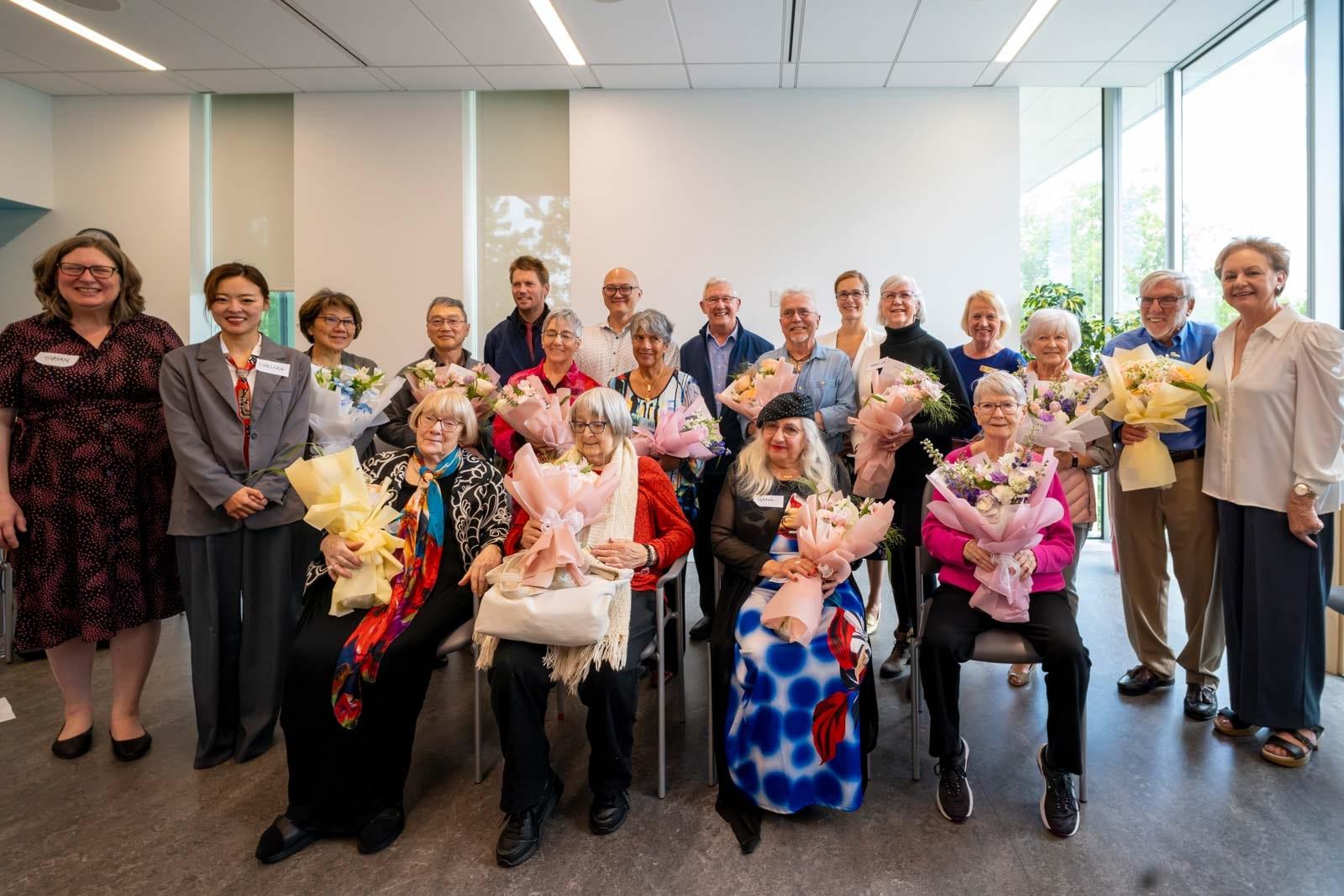 The CACR 2024 Faces of Richmond reception, with senior participants holding flowers and reception guests.
