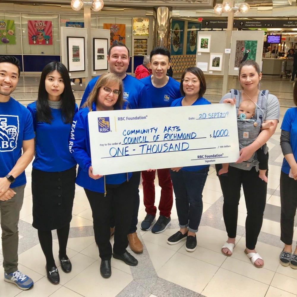 William Mah and his RBC team of volunteers present the Community Arts Council, and artist and former board member Karen Proulx, with a donation at the 8th Annual Midsummer Arts Dream Exhibit at Lansdowne Centre on September 21, 2019.