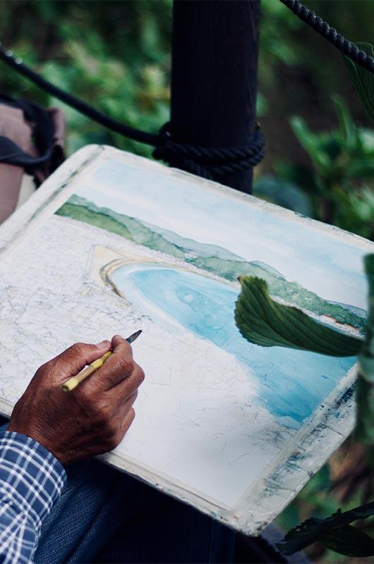 Painting a landscape scene outdoors at a CACR program